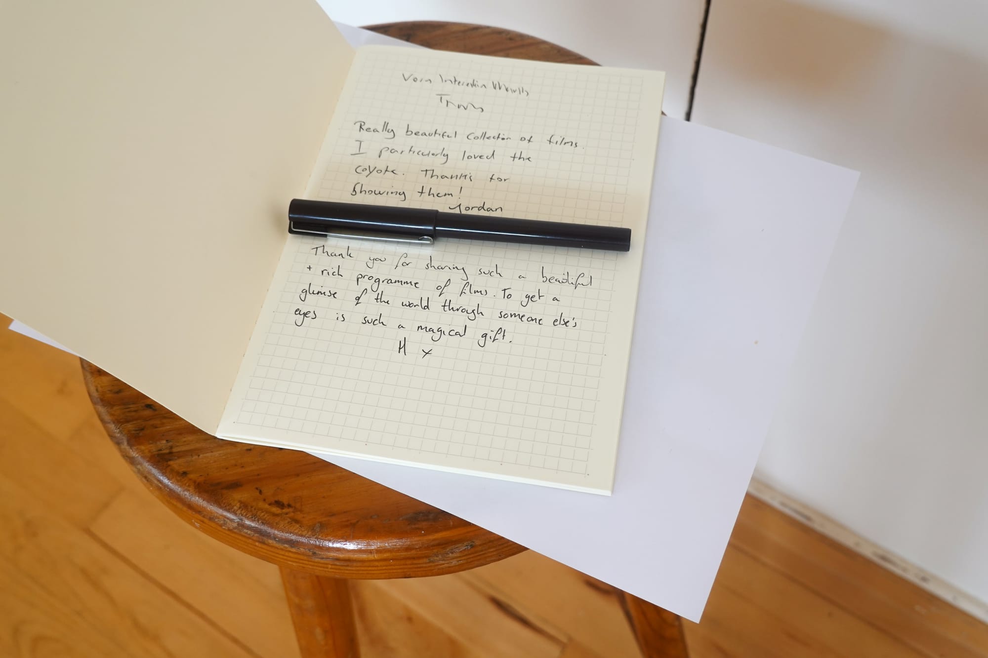 an opened notebook showing messages left by visitors that reads of thanks, and remarks of the event being enjoyed.